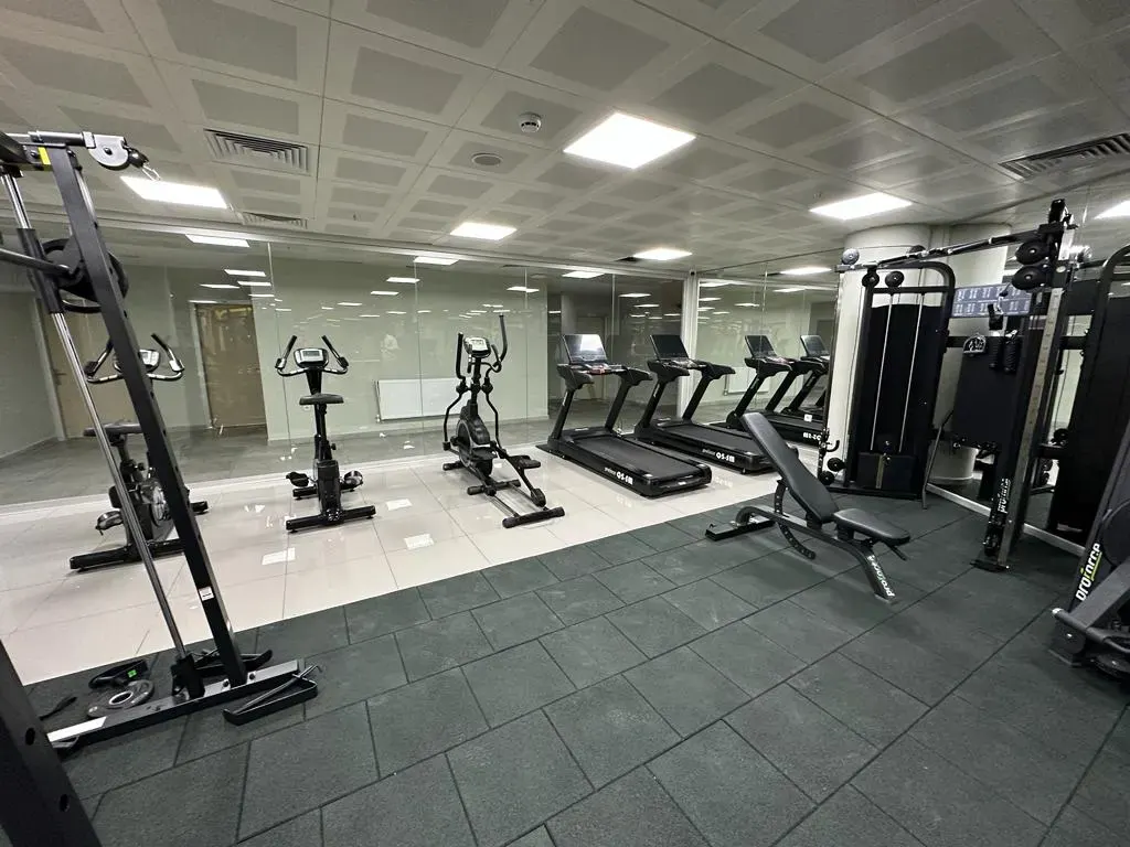 Spacious gym with cardio and sports equipment