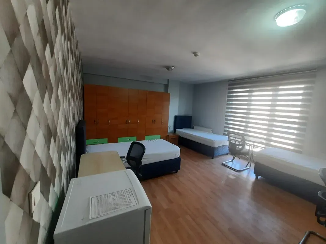 Double room with curtains and wardrobe and two beds in Academia residence